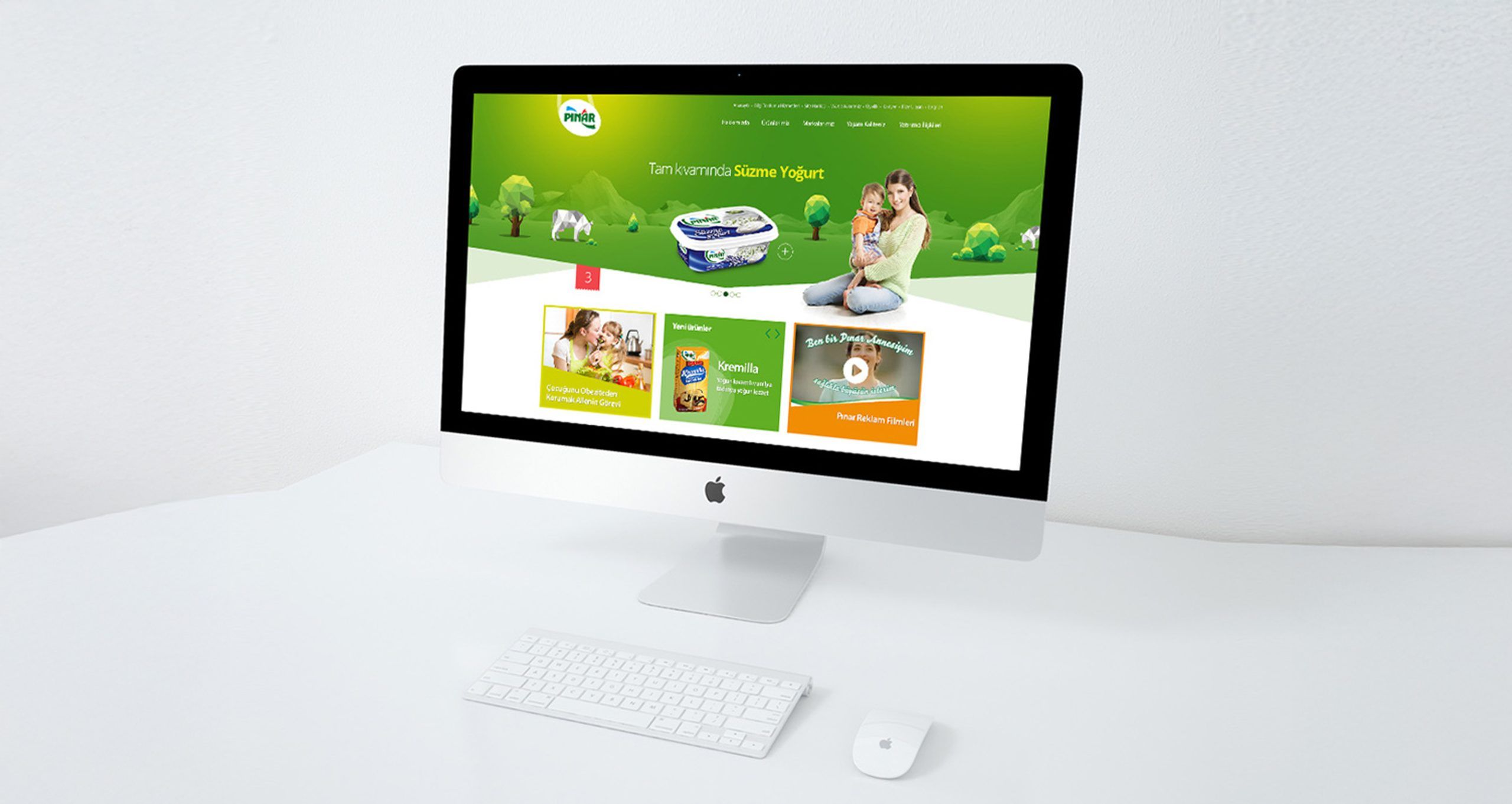 Pınar campaign microsite on an iMac, green layout with family photography and product cards.